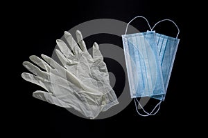 Gloves and masks for protection against viruses on black background