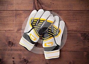 Gloves of the soccer goalkeeper on wooden table