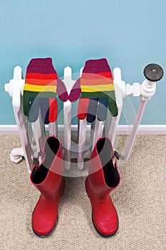 Gloves and wellies on an old radiator photo