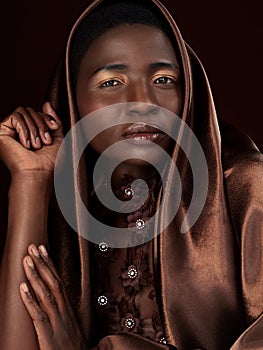 That glow that comes from your soul. Studio portrait of an attractive young woman posing in traditional African attire