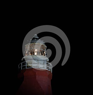 Glow of a lighthouse at night