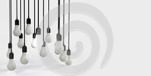 Glowing 3d Light Bulb between the others on a grey light background. Leadership, innovation, great idea and individuality concepts