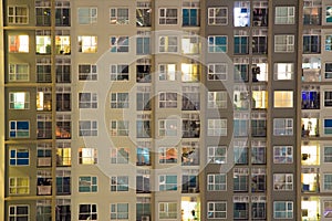 Glowing apartment windows at night where each occupant has his own privacy in the well planned high rise. Electrical power