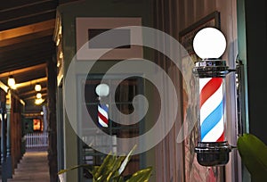 A Glowing Barber Pole on a Shop Porch