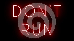 Glowing and blinking red retro neon sign for DON\'T RUN