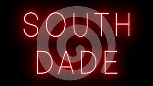 Glowing and blinking red retro neon sign for SOUTH DADE