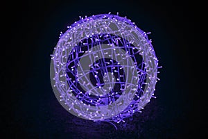 Glowing blue garland in the shape of a ball. Christmas night blue light for holiday.