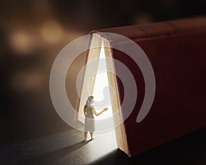 Glowing book with woman.