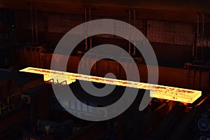 glowing brame in a steel mill - industrial factory for the production of metal sheets