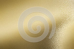 Glowing brushed gold foil metallic sheet, abstract texture background