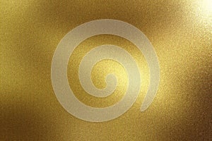 Glowing brushed gold metal wall surface, abstract texture background