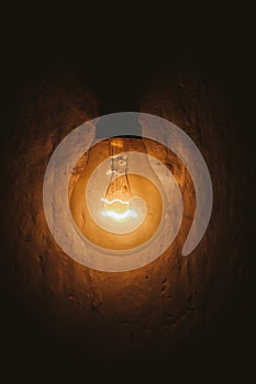Glowing bulb in dark moody baground