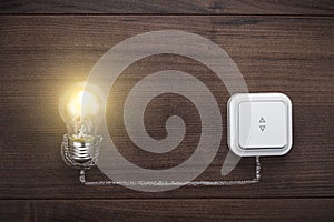 Glowing bulb uniqueness concept on wooden background