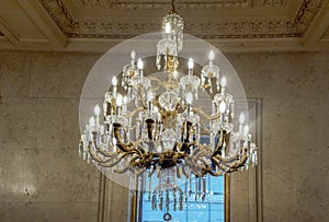 The glowing chandelier against a marble wall One King West Hotel & Residence in the heart of Toronto city, Canada