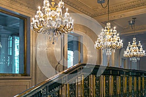 The glowing chandelier against a marble wall One King West Hotel & Residence in the heart of Toronto city, Canada