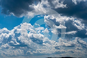 Glowing clouds on a background of blue sky. White fluffy luminous cloud