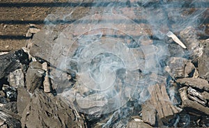 Glowing coals in a barbeque coal fire smoke