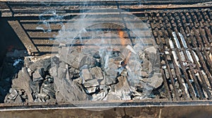 Glowing coals in a barbeque coal fire smoke