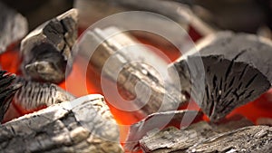 Glowing coals close-up. Charcoal and firewood burning in a grill, close up footage
