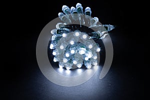 Glowing cold white led pixels christmas holiday lights on black background