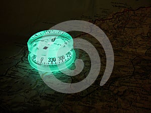 Glowing compass on a map photo