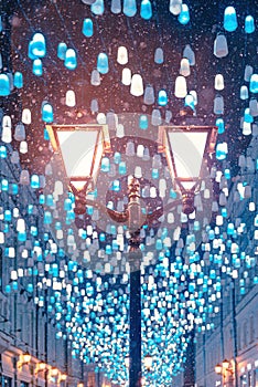 Glowing decorative lanterns. Stoleshnikov pereulok in Moscow.