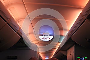 Glowing electrical exit sign on ceiling in Airbus A380