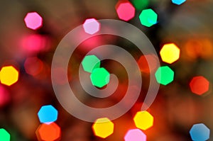 Glowing and festive colored light circles created from in camera and lens bokeh. Christmas fairy lights defocused giving a blurred