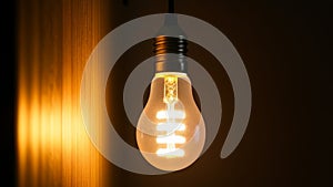 Glowing fluorescent light bulb on dark background with copy space. 3D rendering