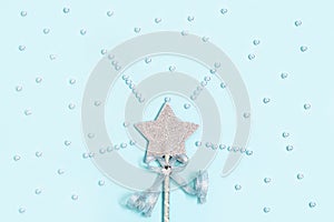 Glowing, glittering star on blue background with white beads. Magic star, fulfillment of wishes, dreams