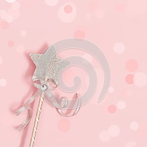 Glowing, glittering star on pink background with bokeh. Magic star, fulfillment of wishes, dreams