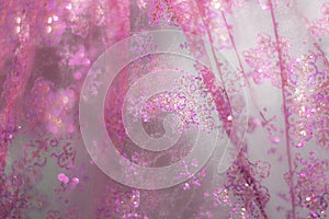 Glowing golden pink festive background with sparkles. Colored abstract blurry backgrounds. Chinese New Year and Christmas