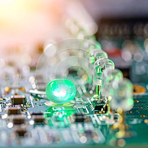 Glowing Green LED on an Electronic Circuit Board