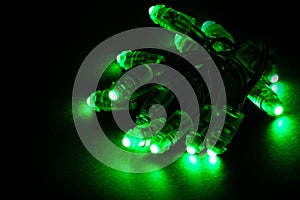 Glowing green led pixels christmas holiday lights on black background