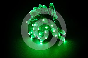 Glowing green led pixels christmas holiday lights on black background