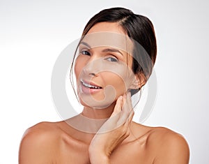 Glowing with happiness. an attractive young woman posing alone in the studio.