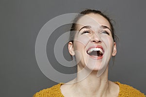 Glowing happiness concept for beautiful girl bursting out laughing