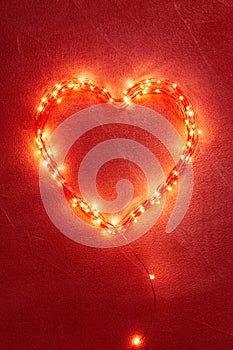 Glowing heart on the red background