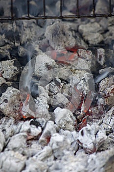 Glowing hot coal ready for cooking, close-up, background texture