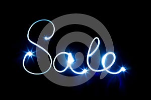 Glowing inscription SALE on a black