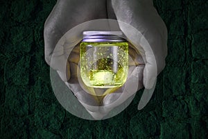 Glowing jar in the hands