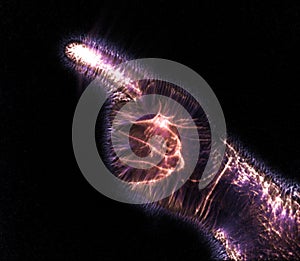 Glowing kirlian coronal aura photography with blue and purple colors of a male human hand