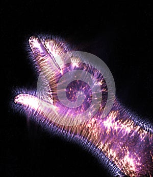Glowing kirlian coronal aura photography with blue and purple colors of a male human hand