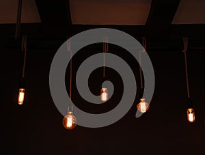 Glowing lamp bulbs in room. Interior element