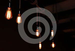 Glowing lamp bulbs in room. Interior element