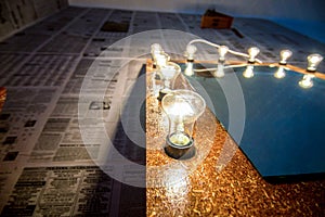 Glowing lamp on chipboard, with mirror