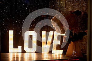 Glowing letters love in the design of a party or night club.Valentine`s day