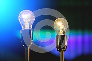 glowing light bulb against blue wall background