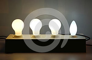 Glowing light bulb in row