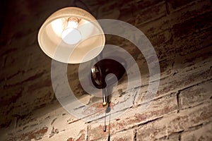 Glowing light bulb on wall